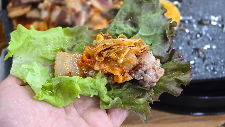Lettuce wrap with pork belly and grilled kimchi