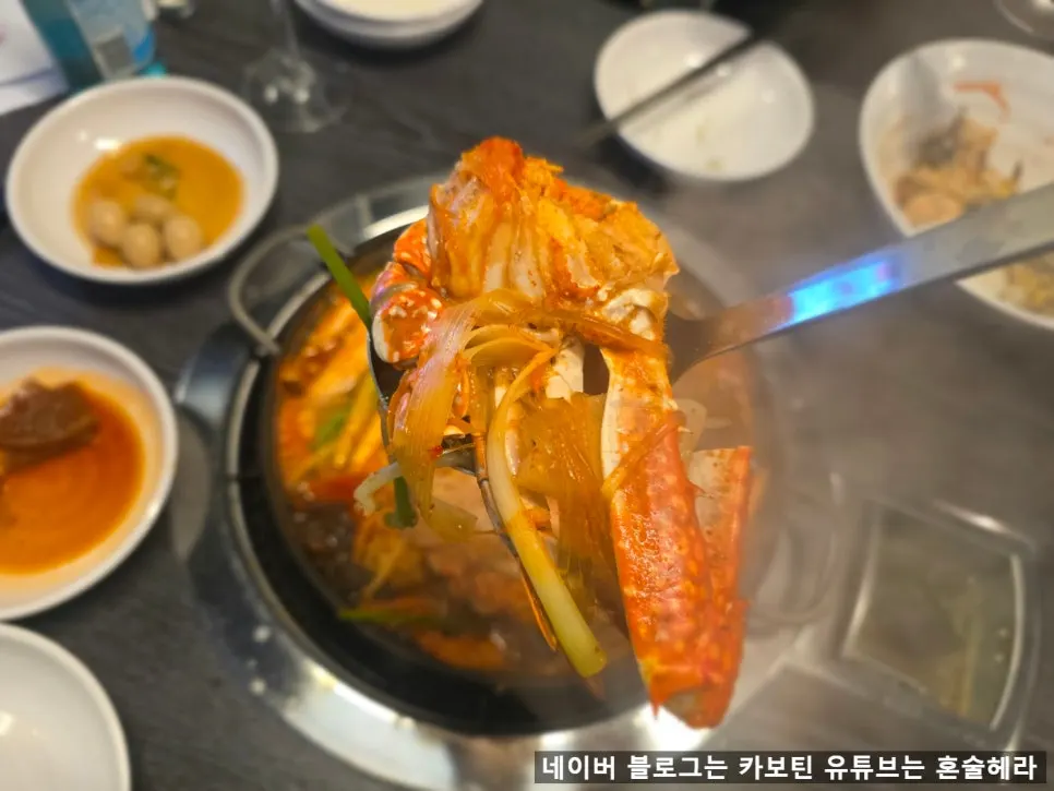 A spoonful of blue crab stew broth