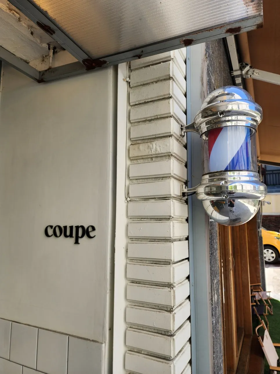 Interior of Coup Barber & Coffee styled like a café
