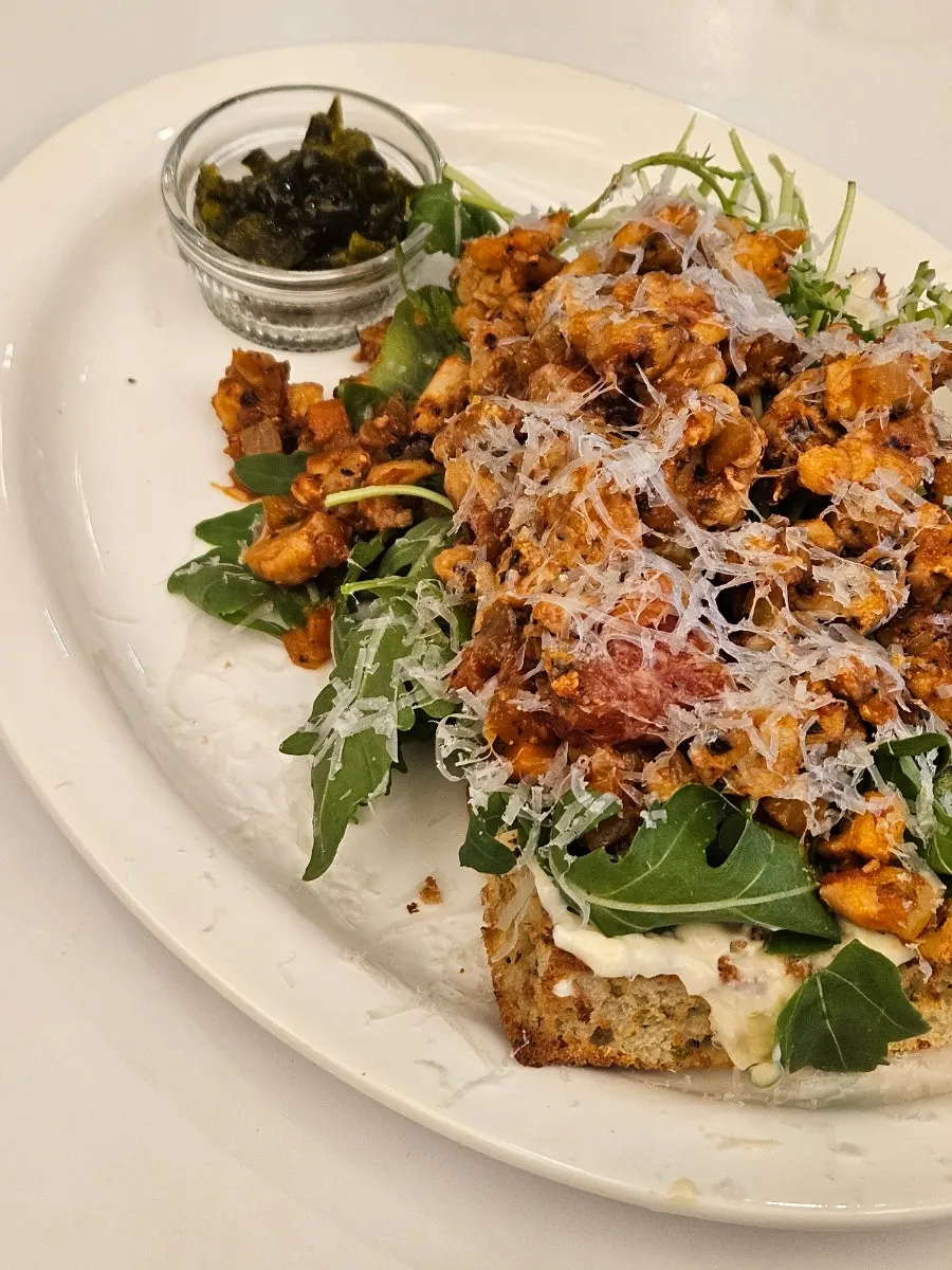 Plate of chipotle chicken topped with arugula
