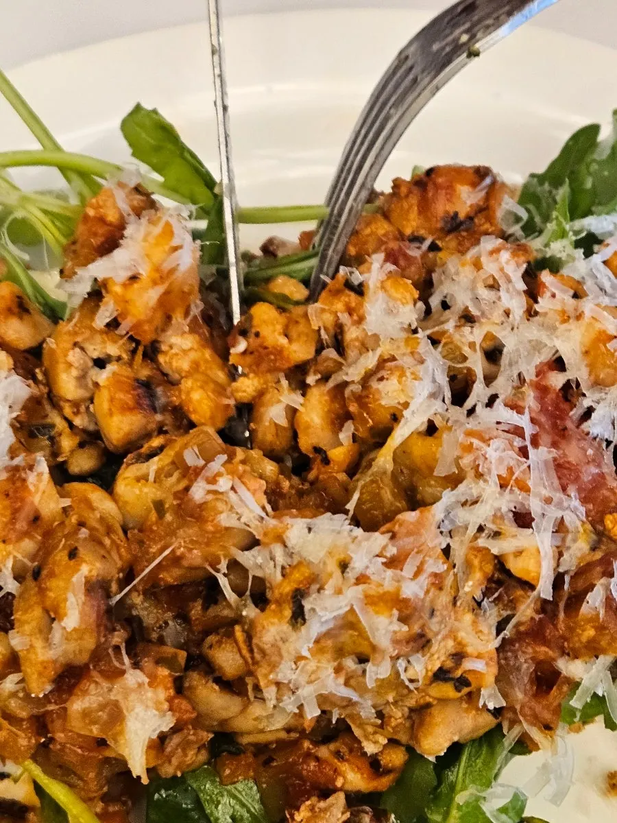 Cross-section of chipotle chicken with arugula