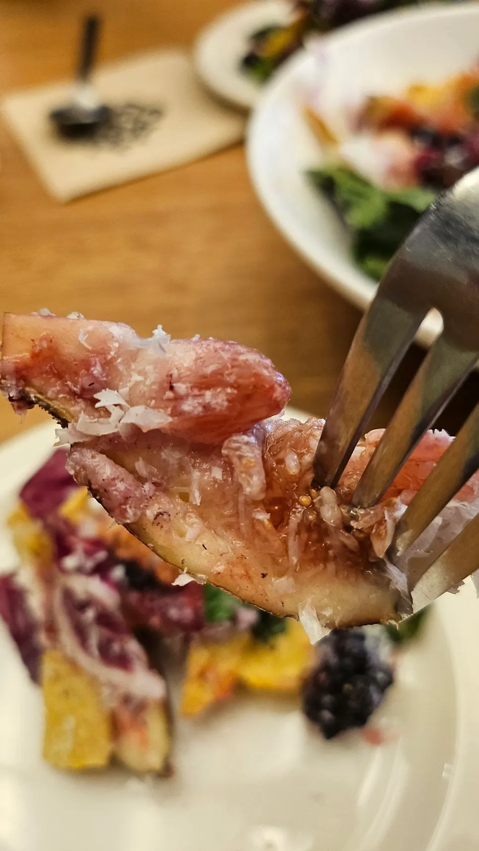 Plate of salad mixed with fruit and olives