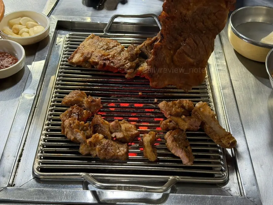 Partially grilled pork king ribs on the grill