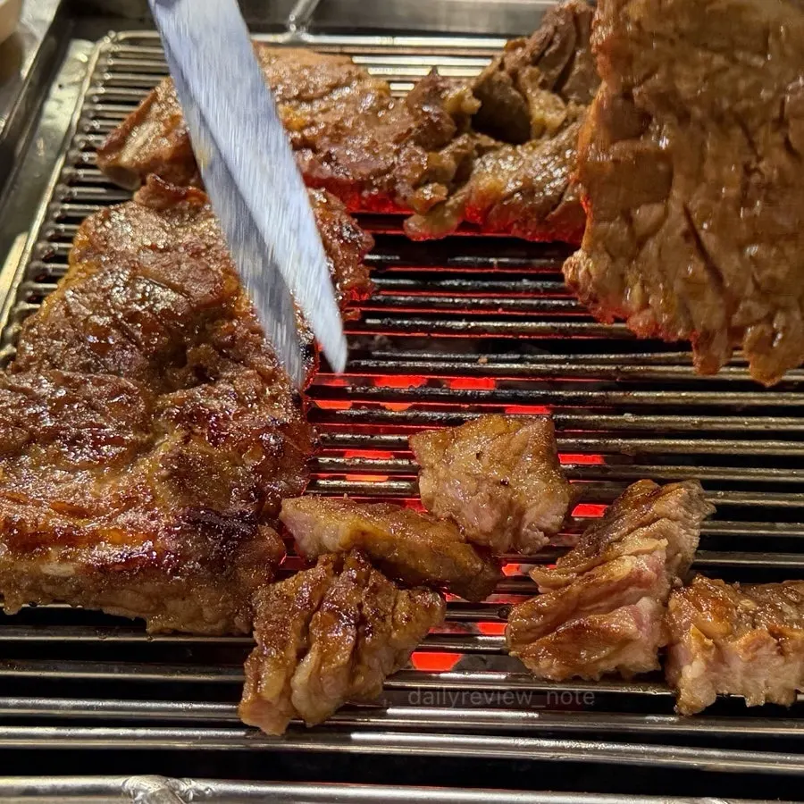 Marinated pork ribs grilling over charcoal
