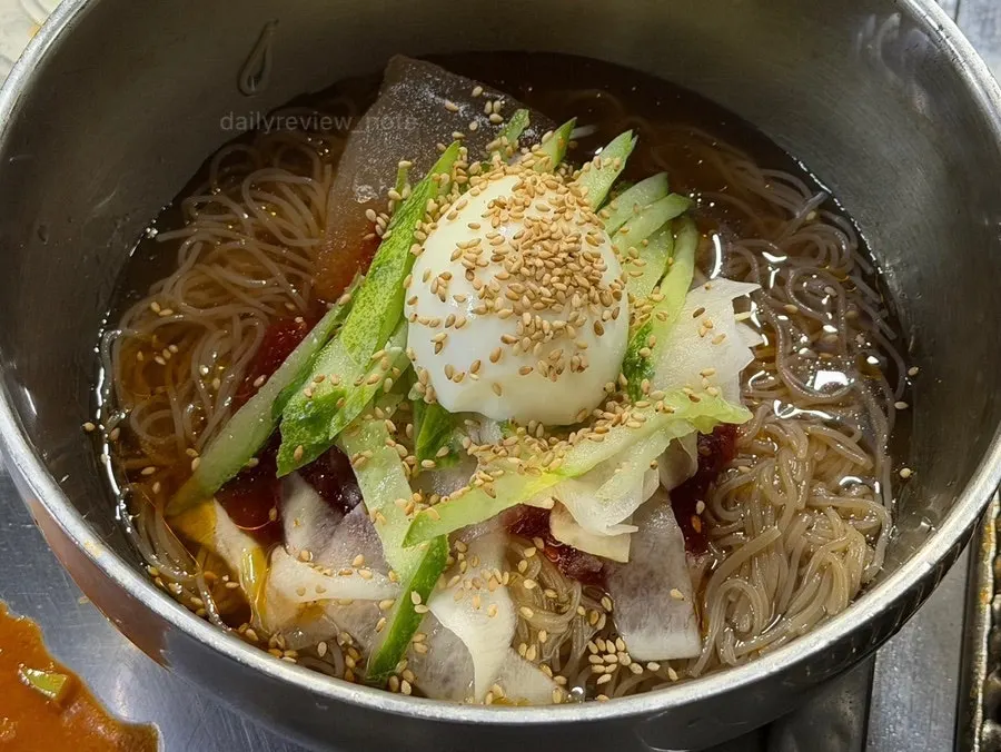 Bibim naengmyeon topped with cucumber and egg