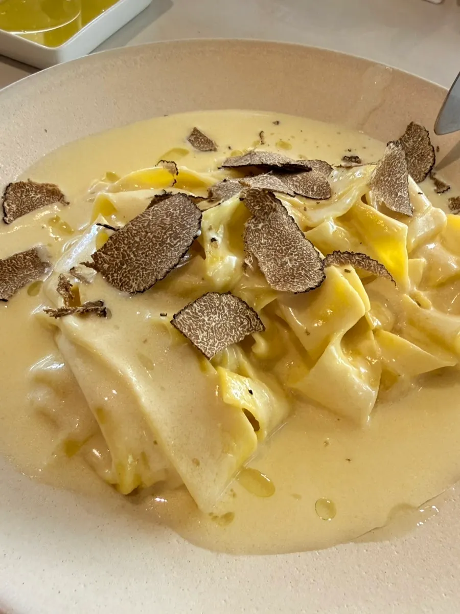 Fresh truffle being shaved over pasta