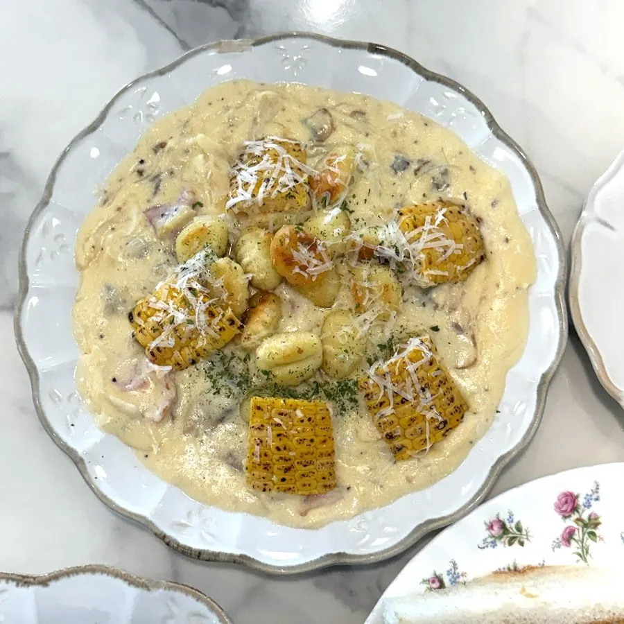 Close-up of gnocchi tossed in corn purée cream