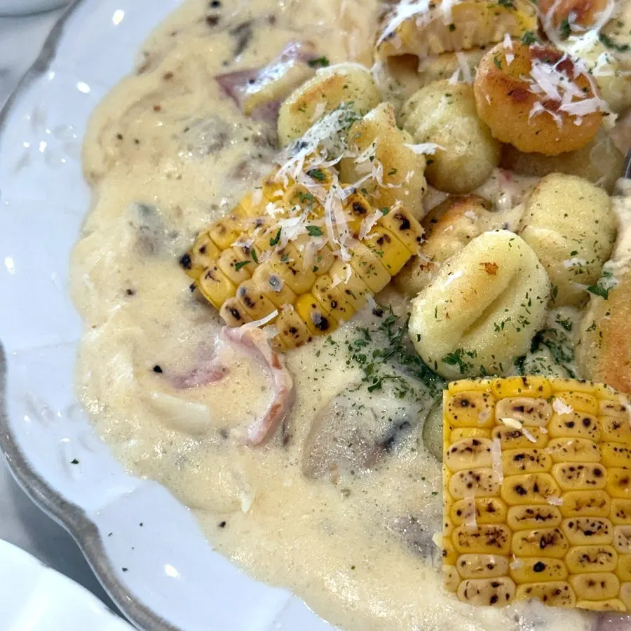 Close-up of gnocchi coated in corn cream