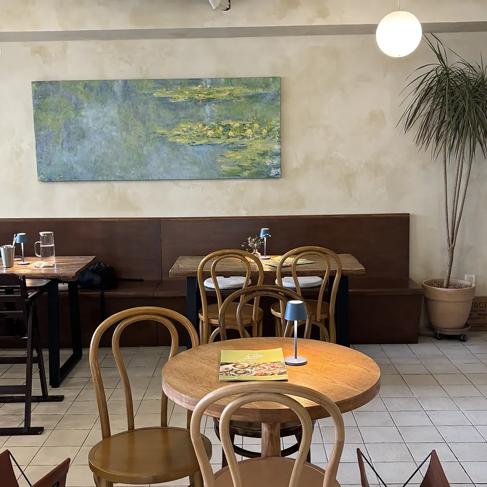 Indoor seating with wide table spacing at Le Bon Goûter