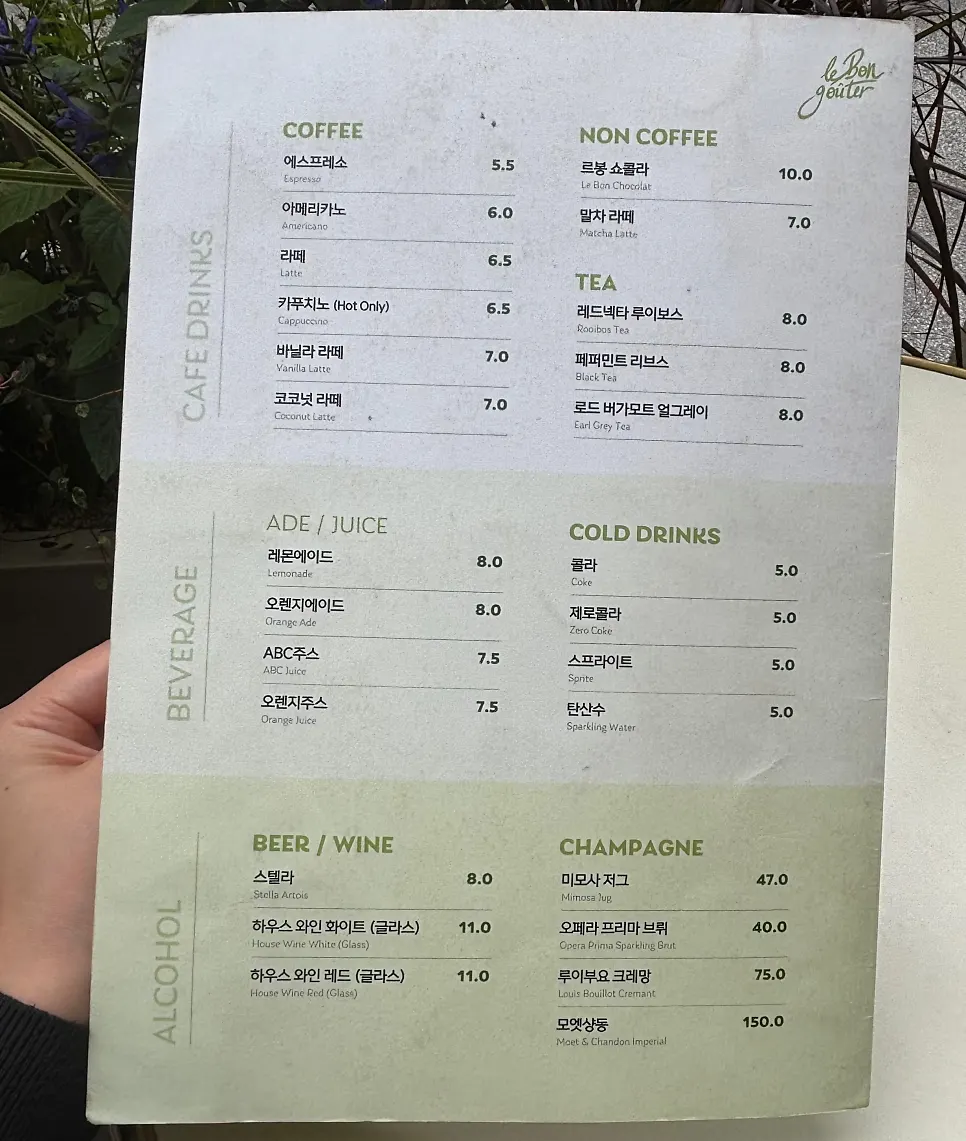 Menu board listing desserts and drinks at Le Bon Goûter