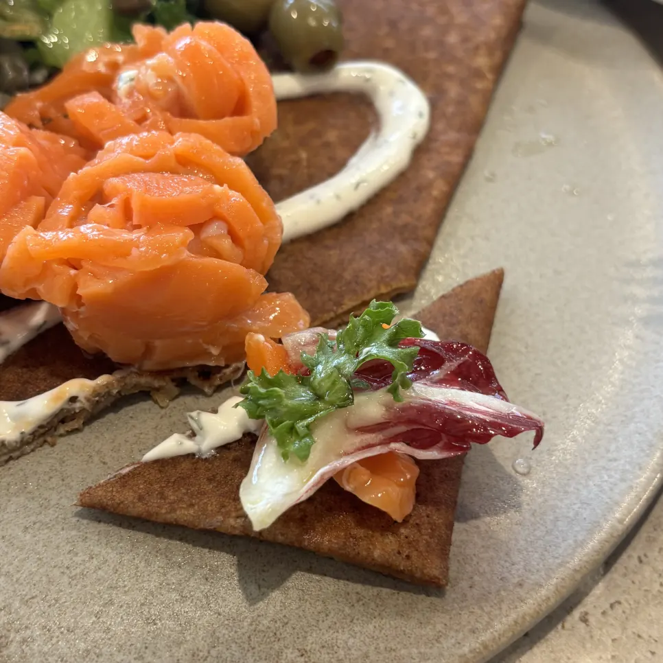 Cross-section of a sliced smoked salmon galette