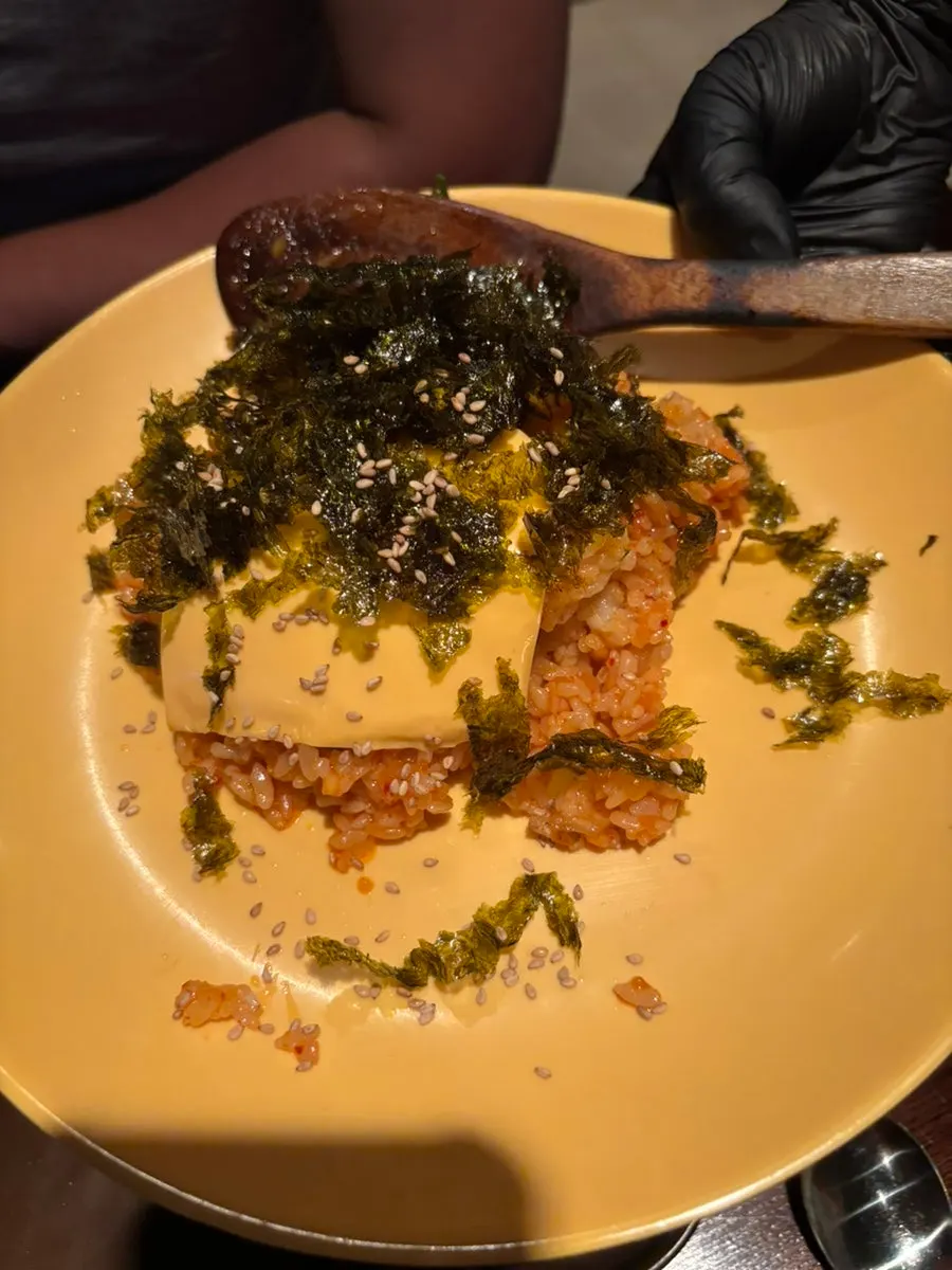 Fried rice topped with seaweed flakes and cheese