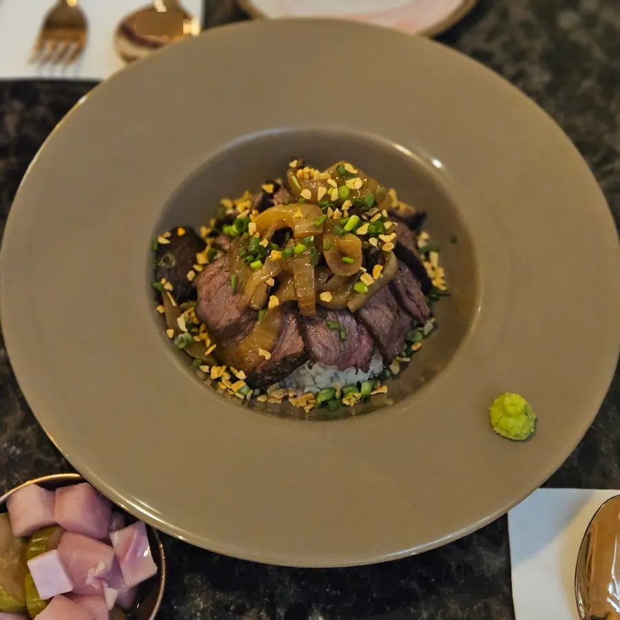 A bowl of rose steak rice bowl