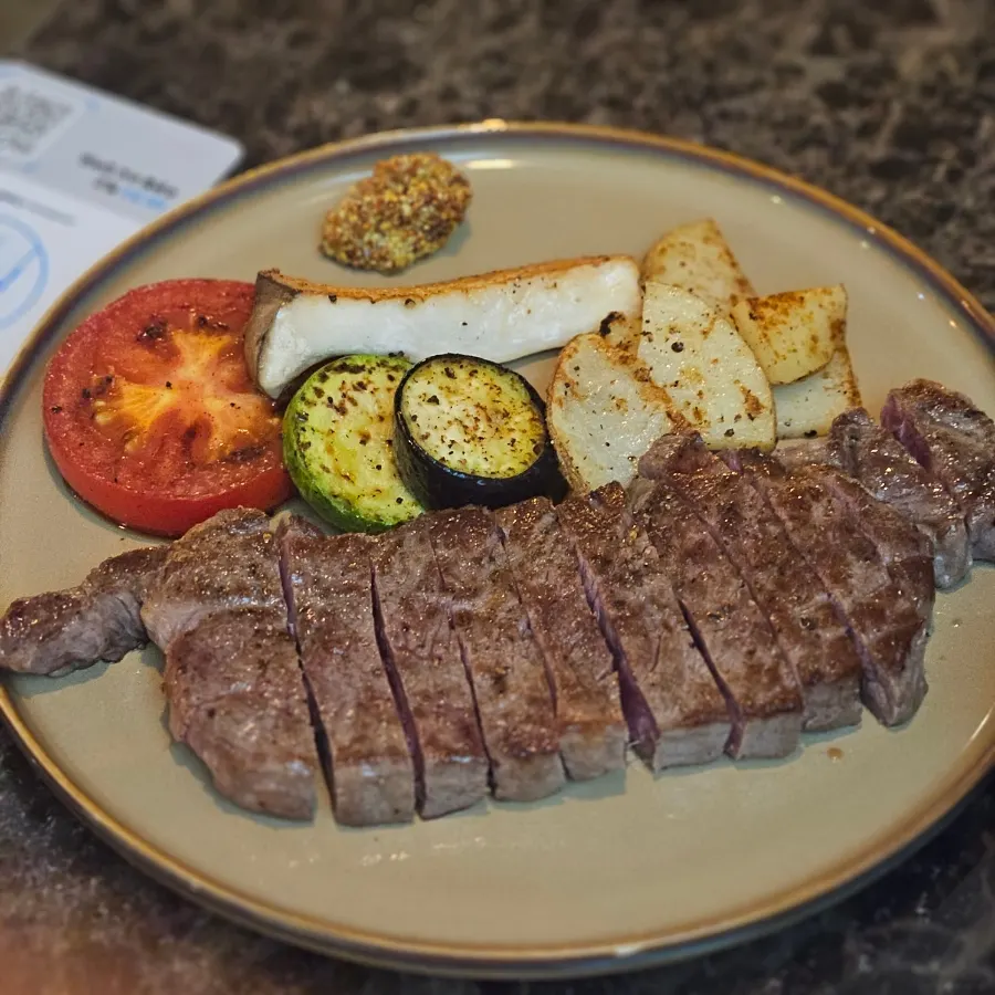 A plate of Hanwoo rose steak with grilled vegetables