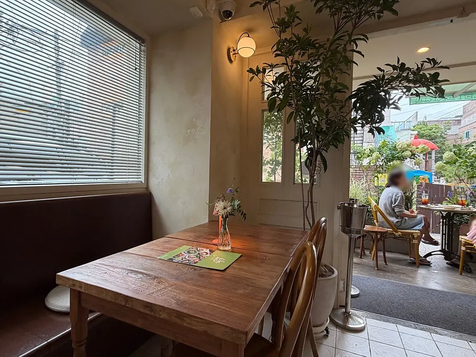 Terrace seating and plants at Le Bon Goûter