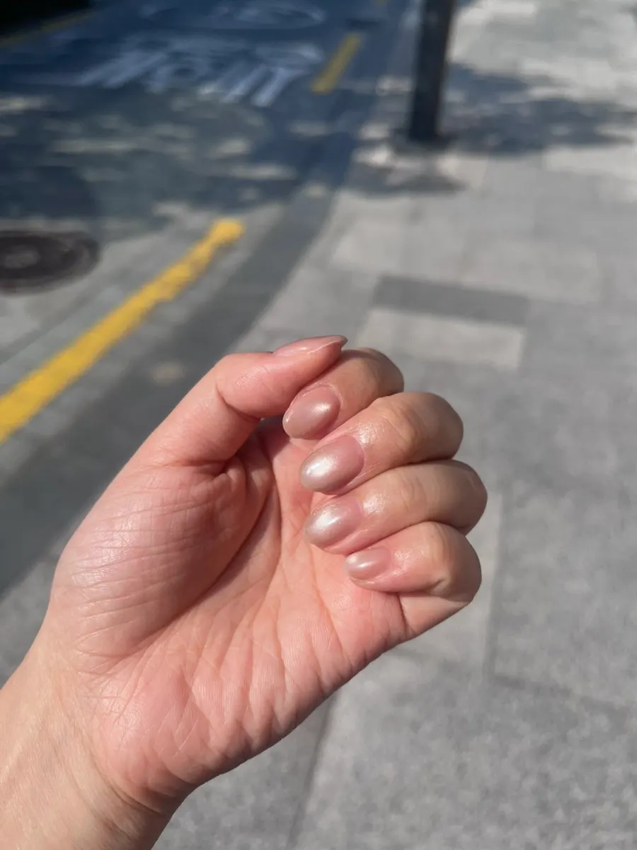 Pink magnetic shimmer nails under lighting