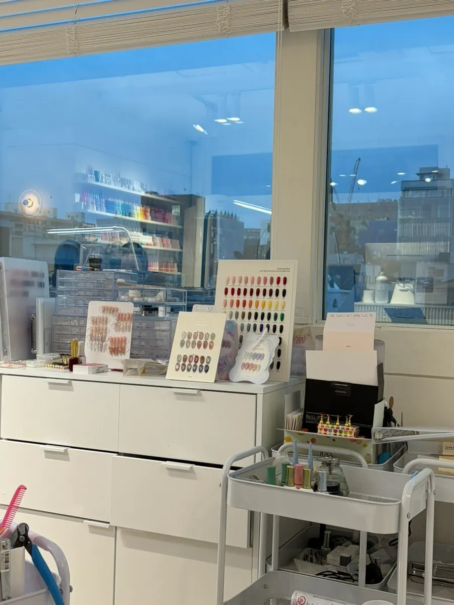 White-toned nail salon interior with floor-to-ceiling windows