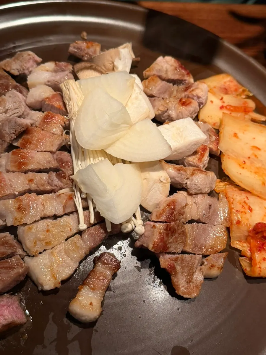 Meat and kimchi grilled by a staff member