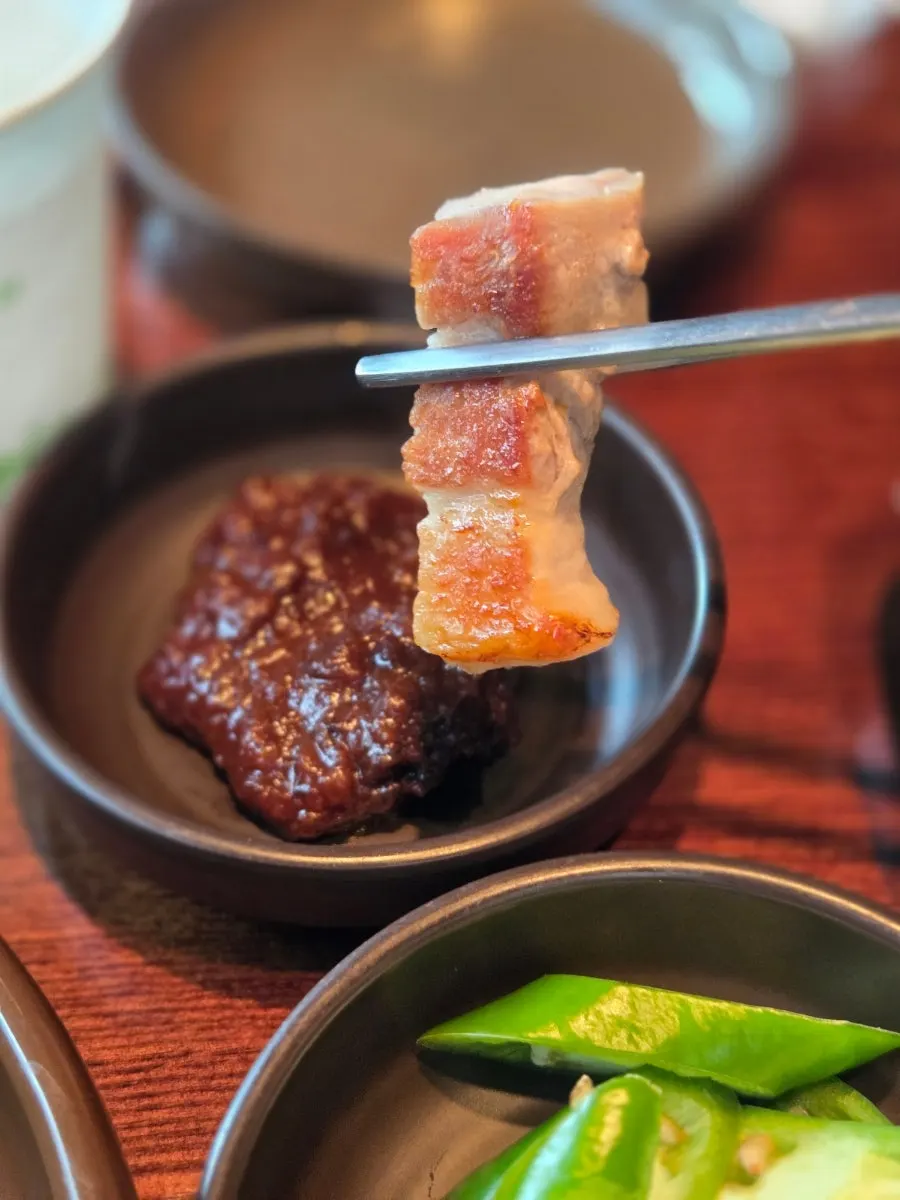 Par-grilled pork cooking at the table