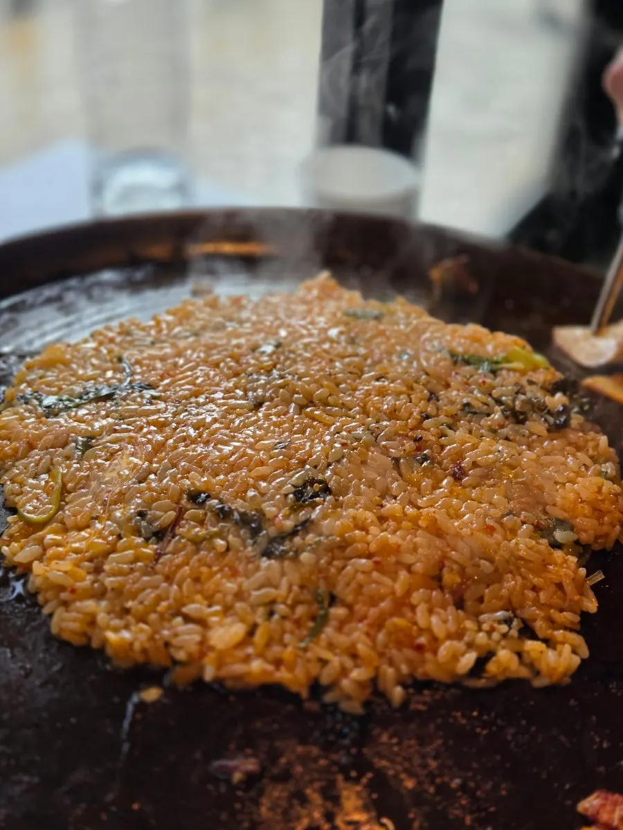 Fried rice topped with seaweed flakes and cheese