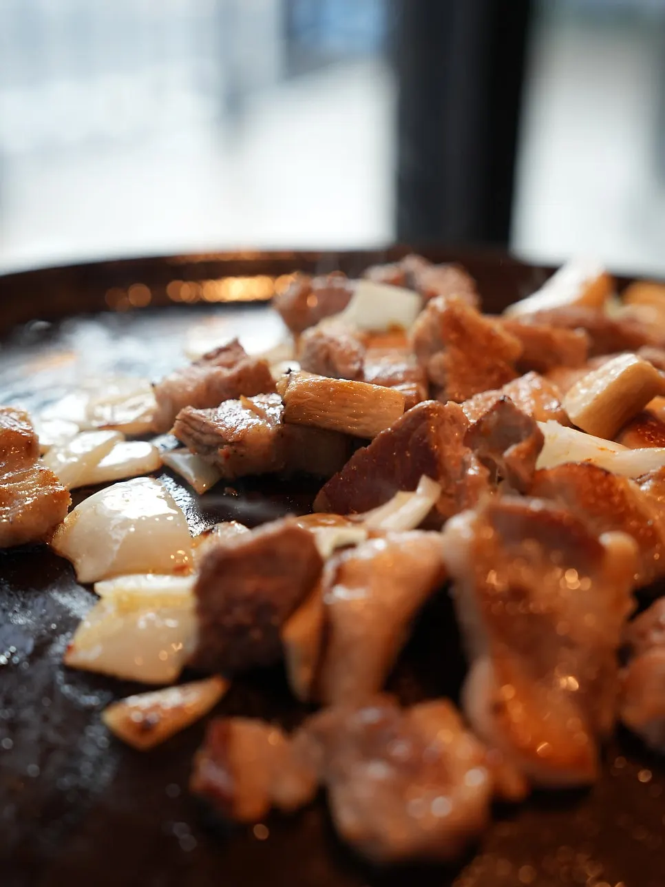 Par-grilled meat on an earthenware grill