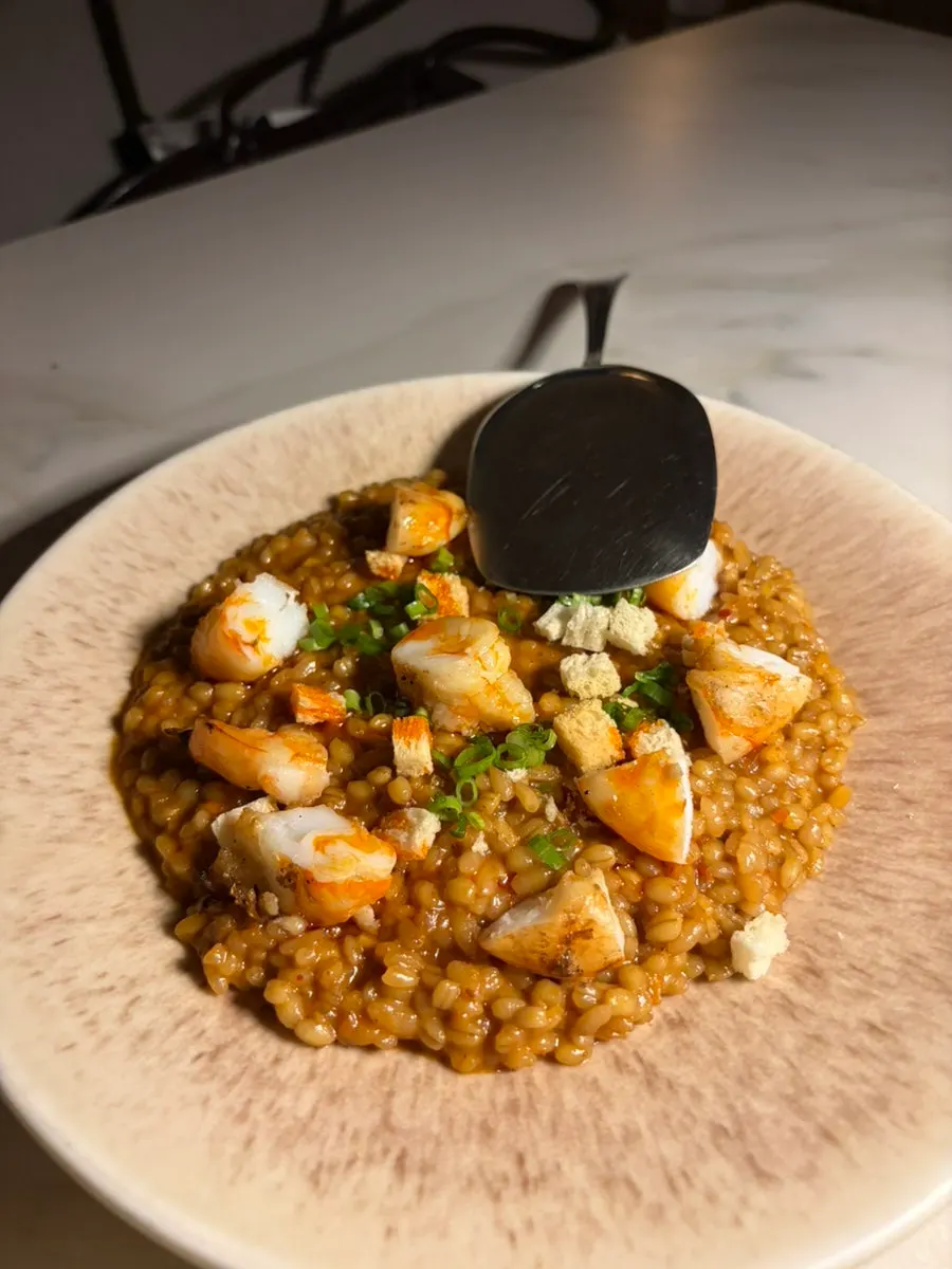 Shrimp bisque risotto topped with shrimp