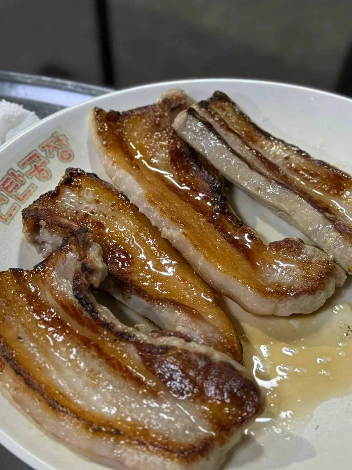 Pork belly grilling over the charcoal briquette