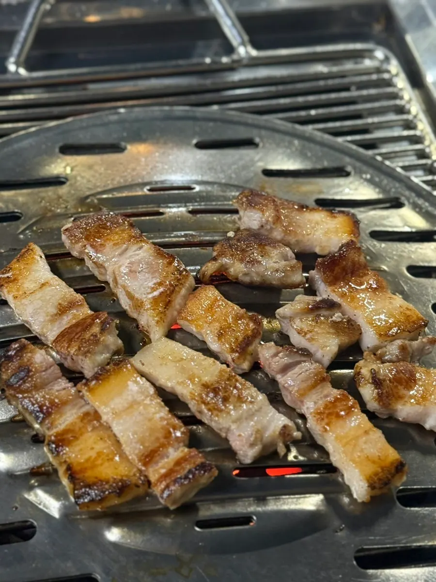 A small dish of salt served with the pork belly