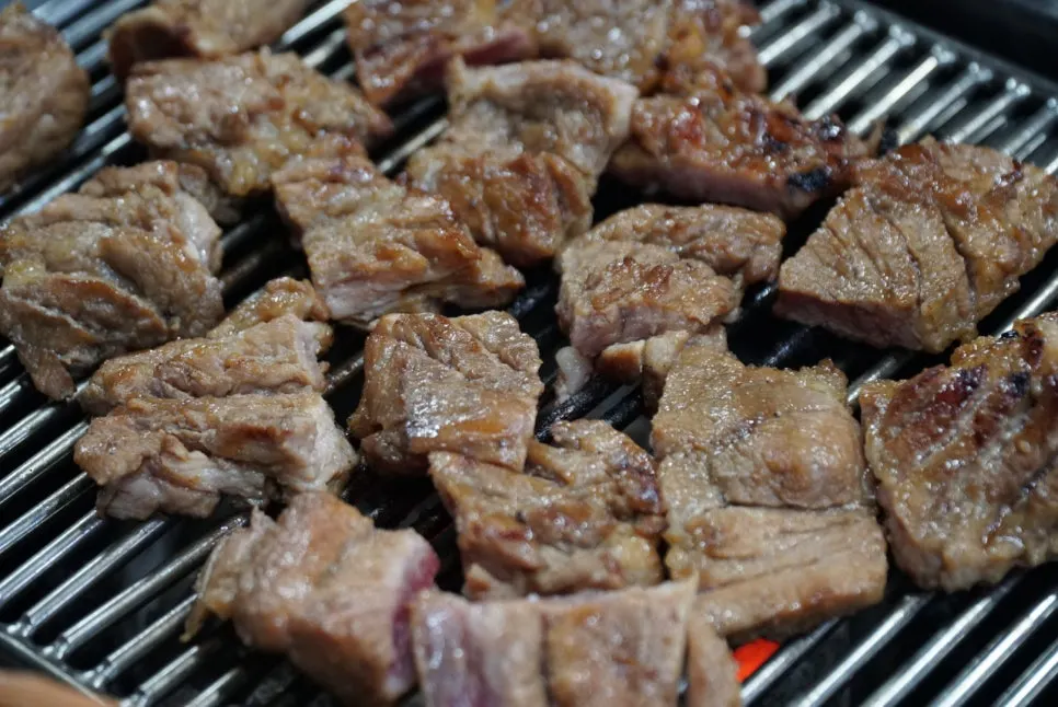 Two servings of seasoned pork ribs on the grill
