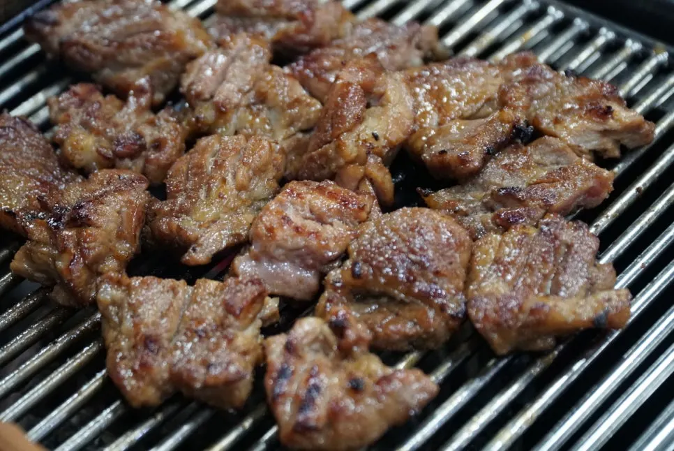 Flipping the seasoned pork ribs while cooking