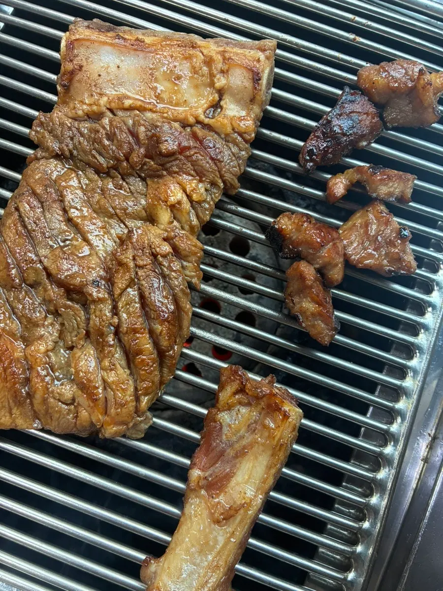 Pork king ribs cooking on the grill