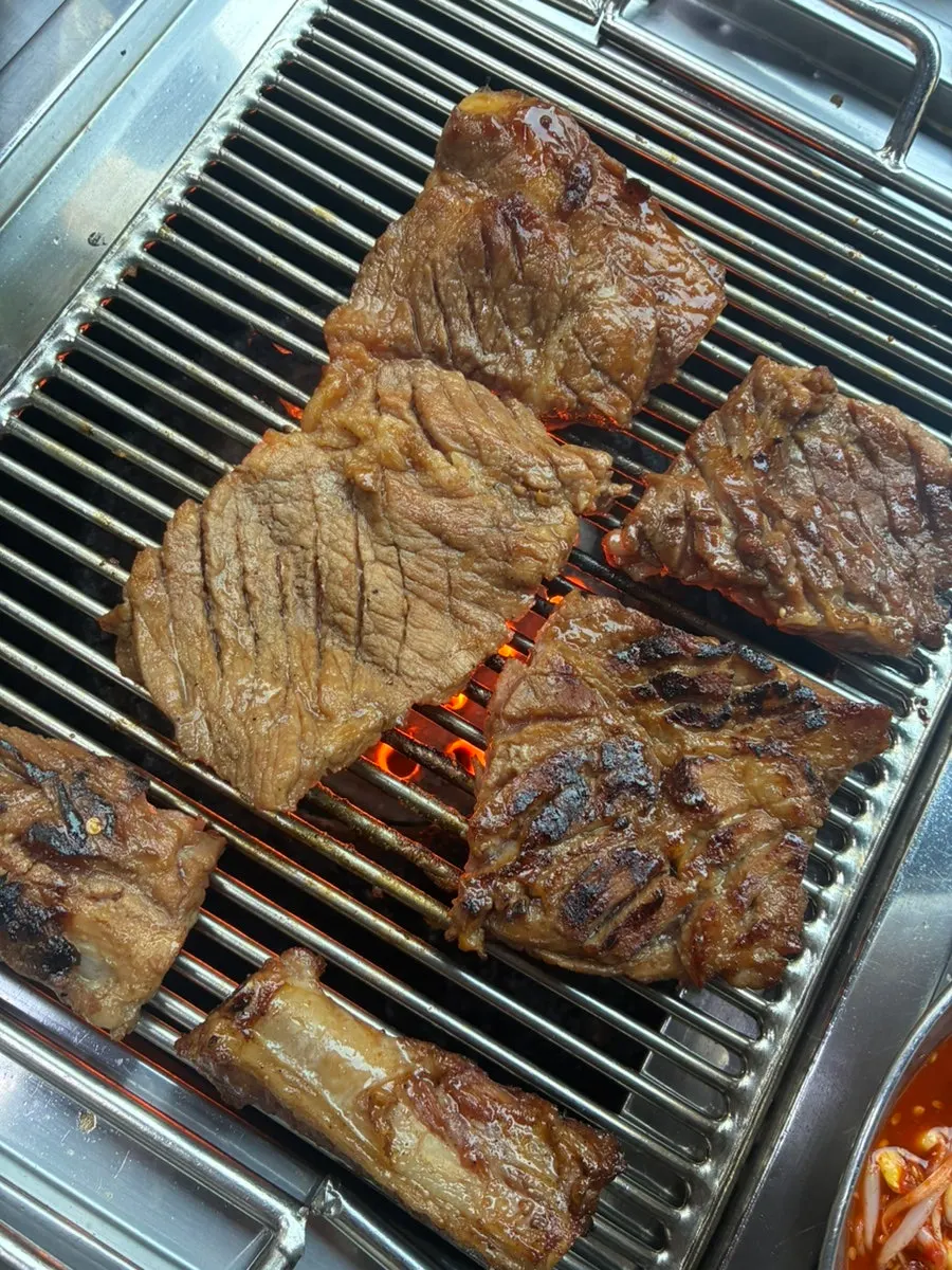 Close-up of pork ribs over charcoal fire