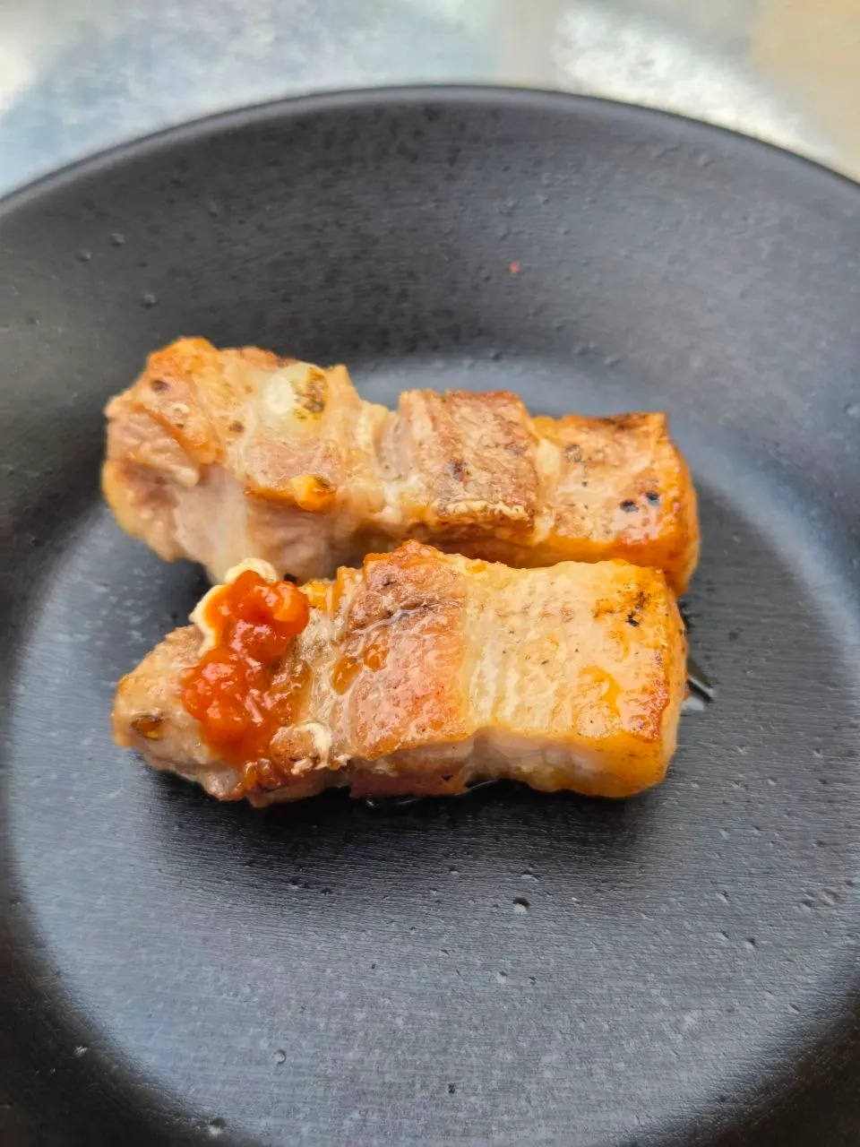 A well-grilled piece of pre-seared pork belly