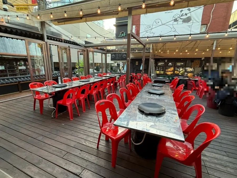 Chobeoljip interior with wood-toned decor and a landscape-painting mural