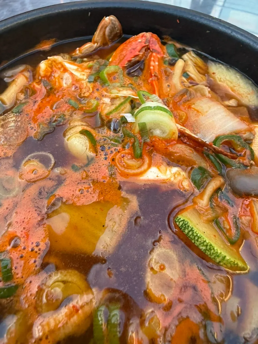 Bubbling stew served with wrap vegetables