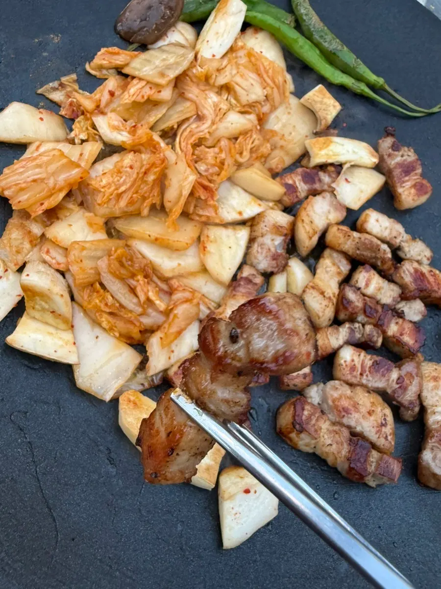 A piece of pork belly topped with fresh wasabi