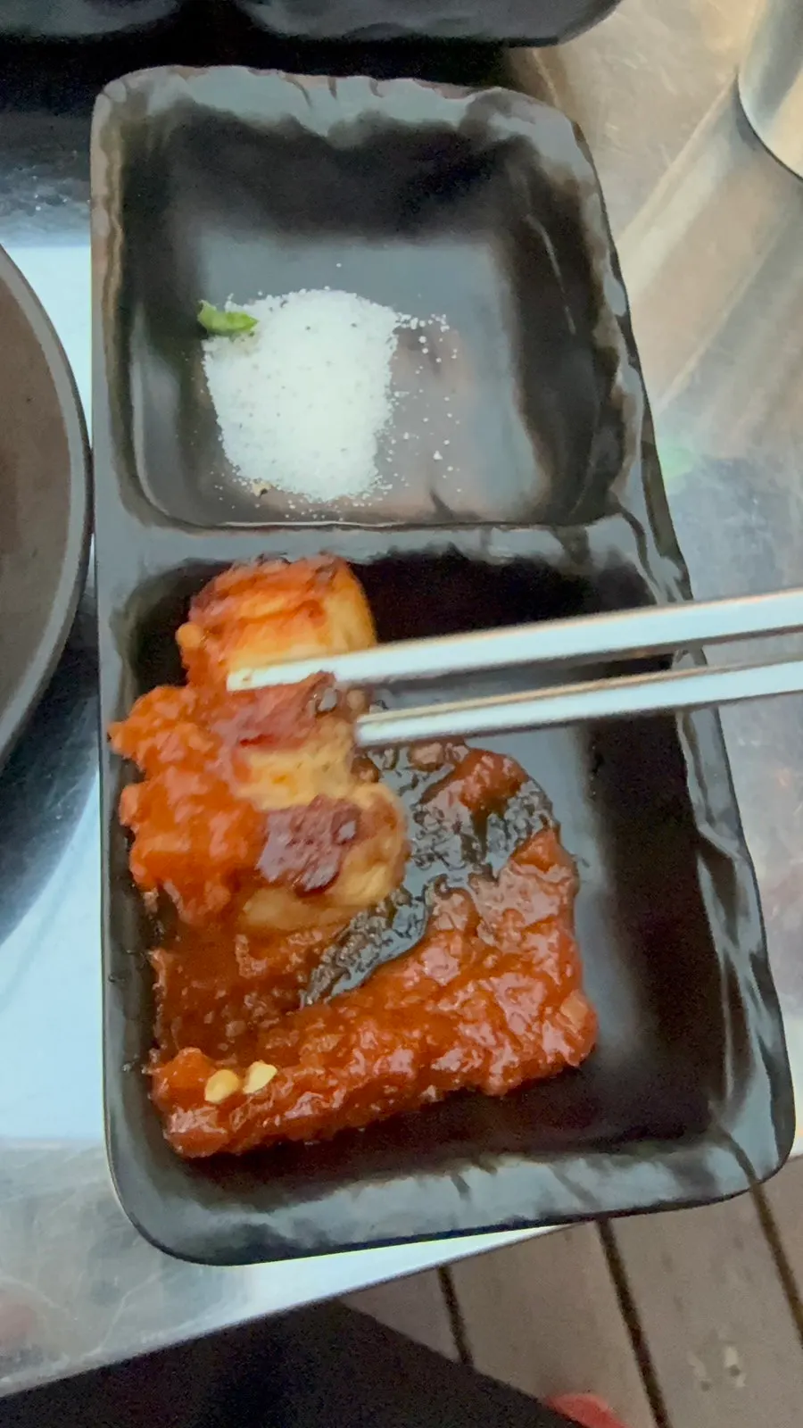 Close-up of a piece of pork belly eaten with ssamjang