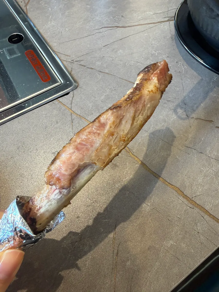A back-rib bone wrapped in foil