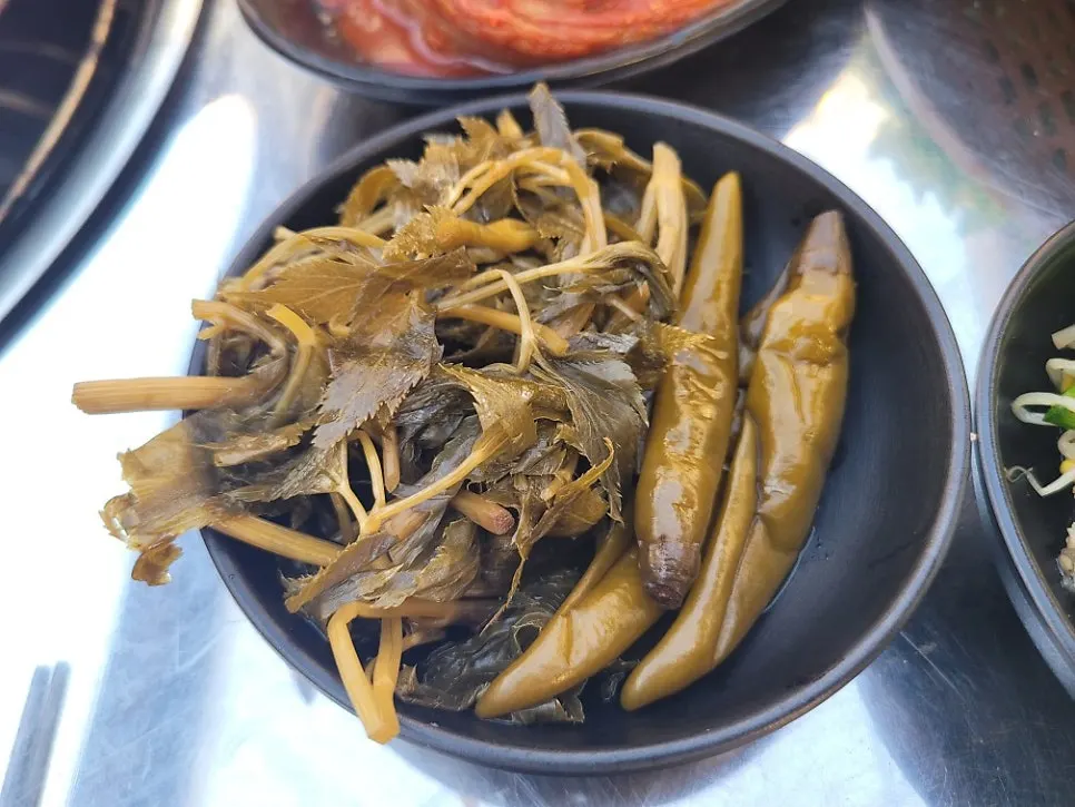 Aged kimchi and side dishes in a meat table setting
