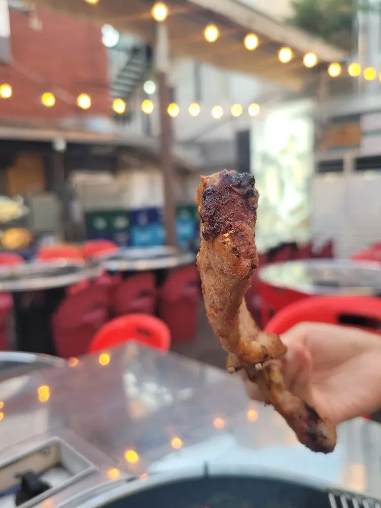 The final moments of a pre-grilled bone pork belly meal