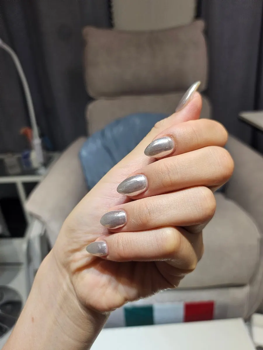 Bright silver gel nails on warm-toned skin