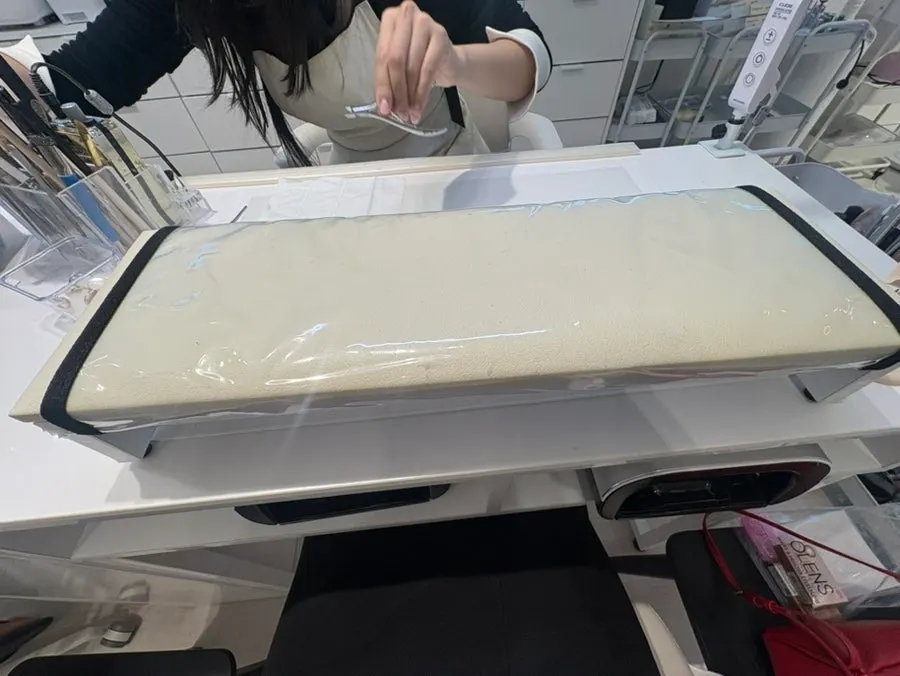A nail treatment table by the window