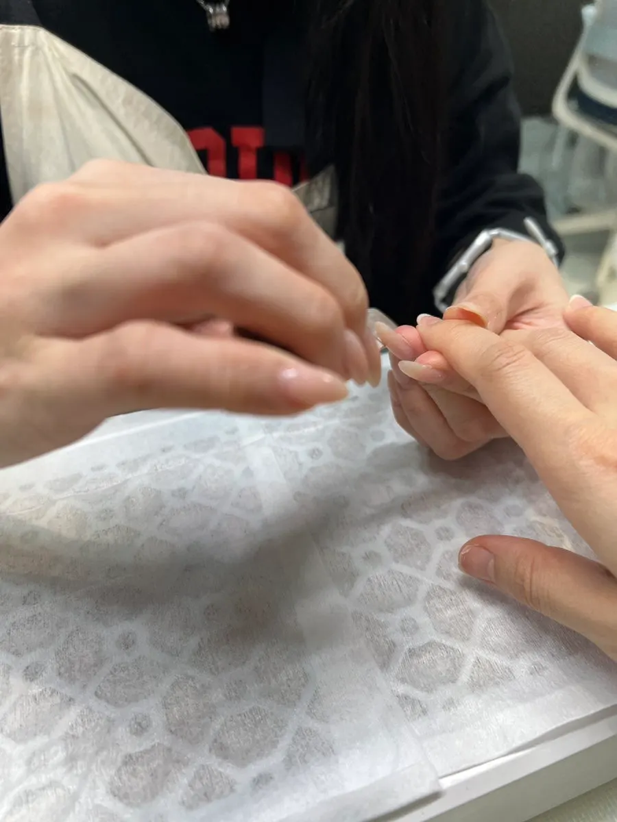 Shaping the nails into an almond shape during the treatment