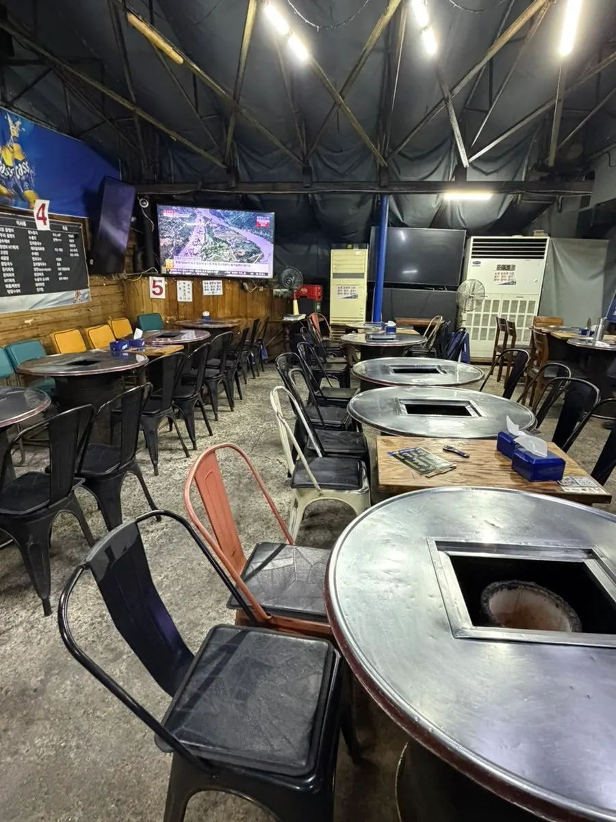 Seating at Yeontan Gongjang with the cover pulled back to reveal the sky
