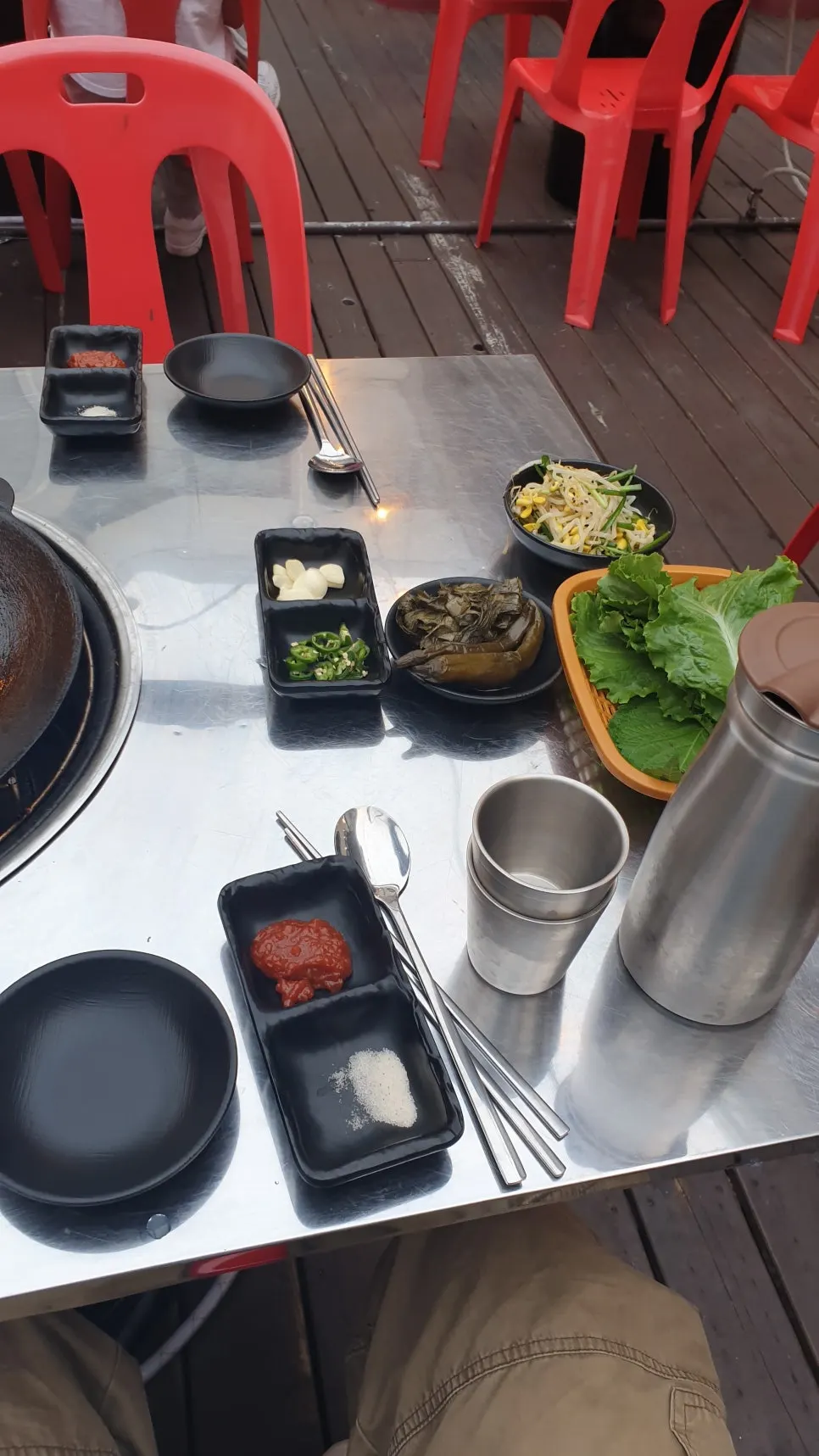 Basic table setting with herbal-scented pickles served before the meat