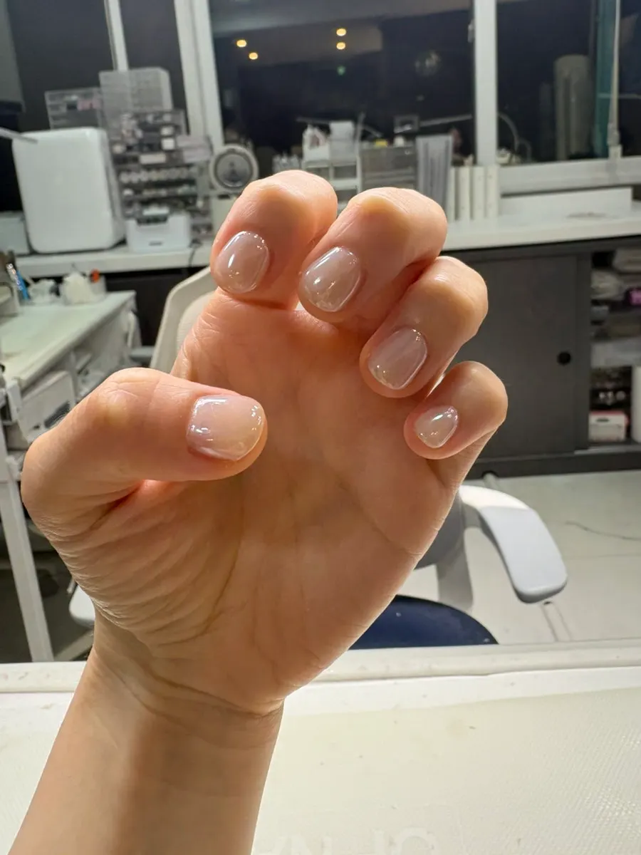 Powder nails glowing pearl-like in the light