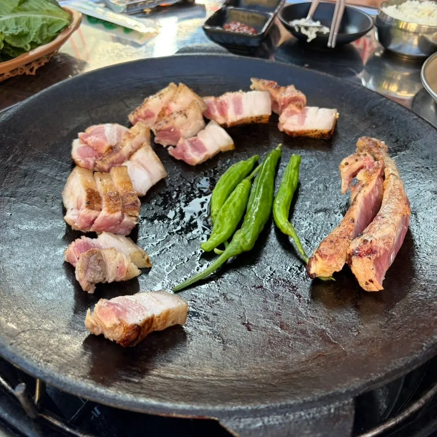 Par-grilled bone-in pork belly on the grill