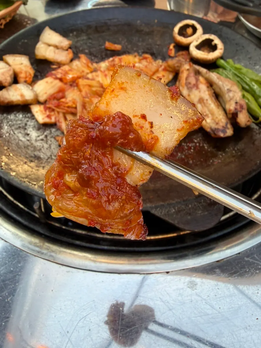 Bone-in pork belly with aged kimchi and shishito peppers