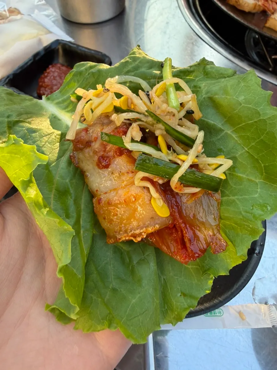 Bone-in pork belly served as a lettuce wrap