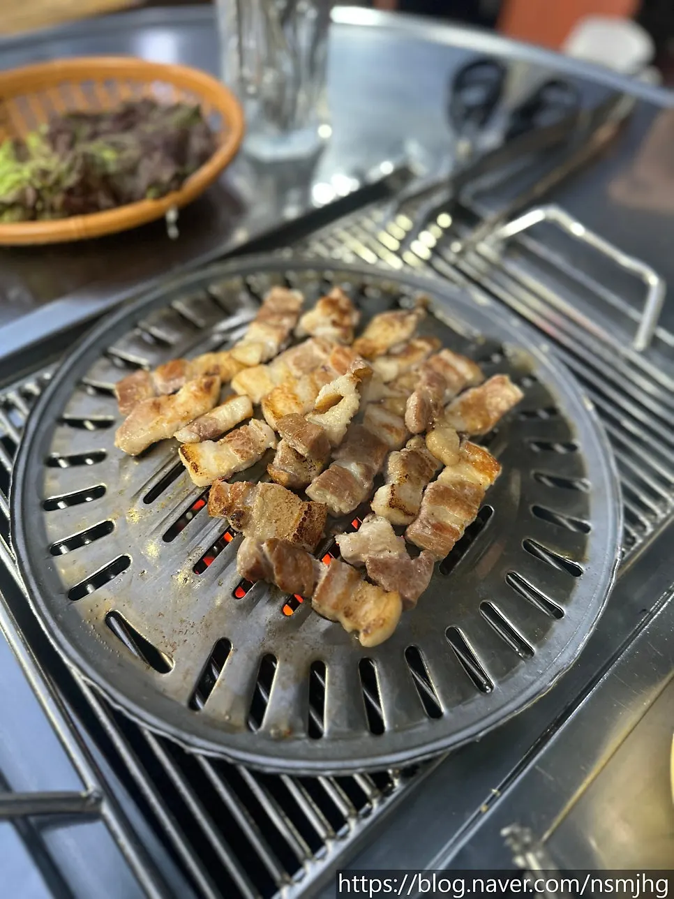 Samgyeopsal browning nicely on the charcoal grill
